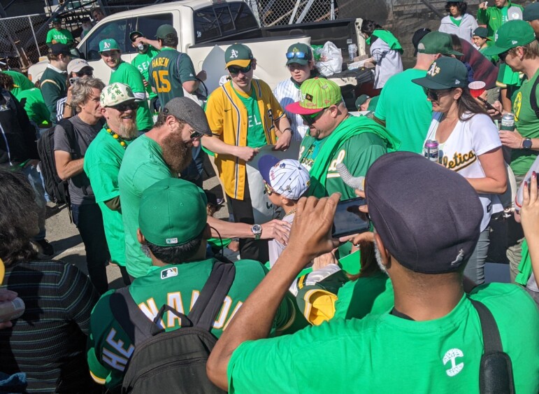 Dallas Braden, famed former pitcher for the A's, greets a young fan at Tuesday's game.