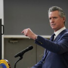 California Governor Gavin Newsom at a podium and microphone