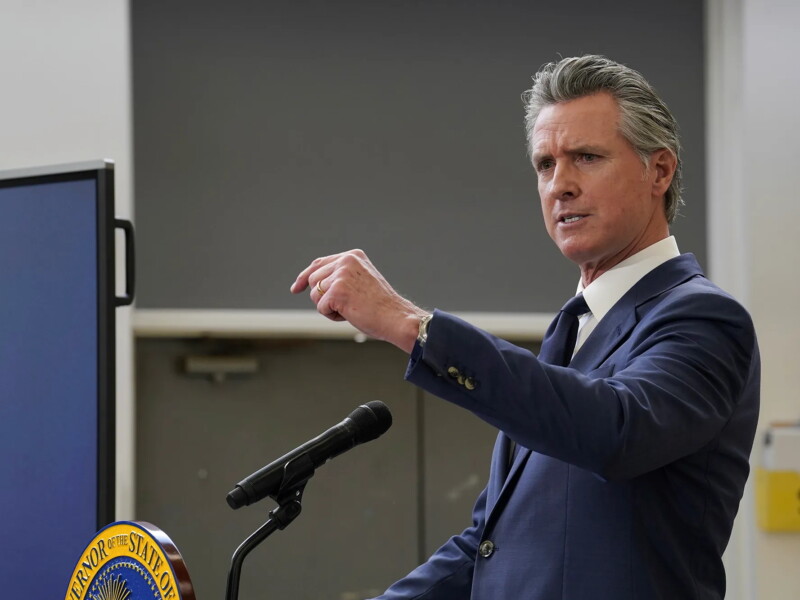California Governor Gavin Newsom at a podium and microphone