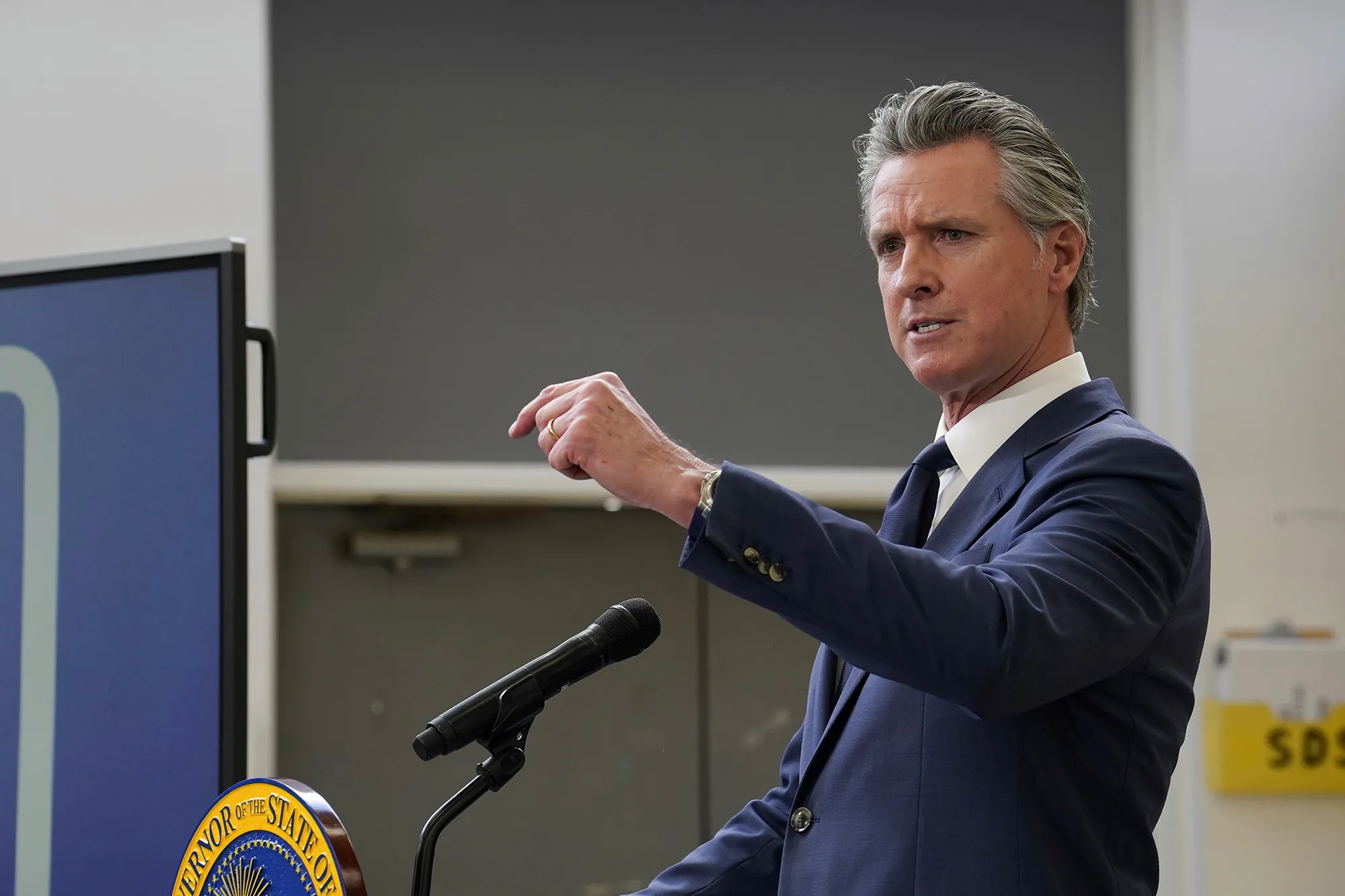 California Governor Gavin Newsom at a podium and microphone